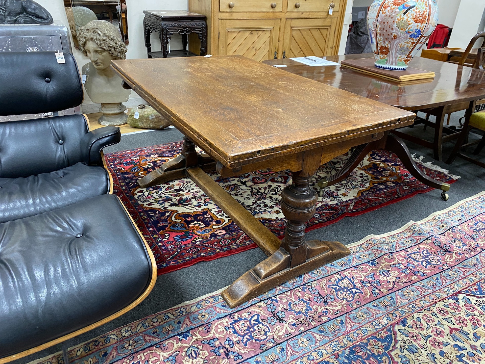 A 1930's oak draw leaf dining table, length 136cm, width 83cm, height 74cm